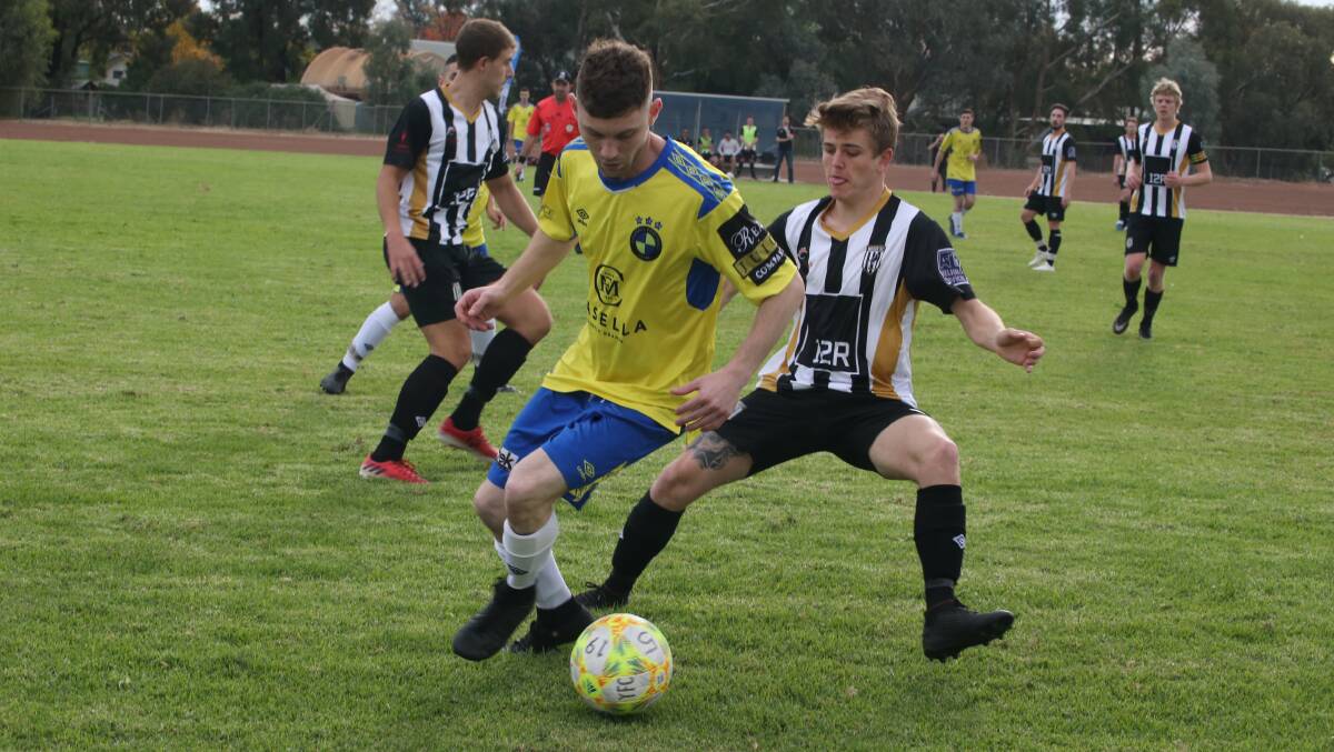 QUICK TURN: YFC's Dominic Perre looks to get around the Wests defence during their clash at the start of the season. PHOTO: Anthony Stipo