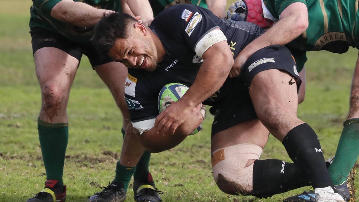 DOWN: Blacks' Chris Latu charge is stopped by the Ag College defence during their clash on Saturday. PHOTO: Les Smith