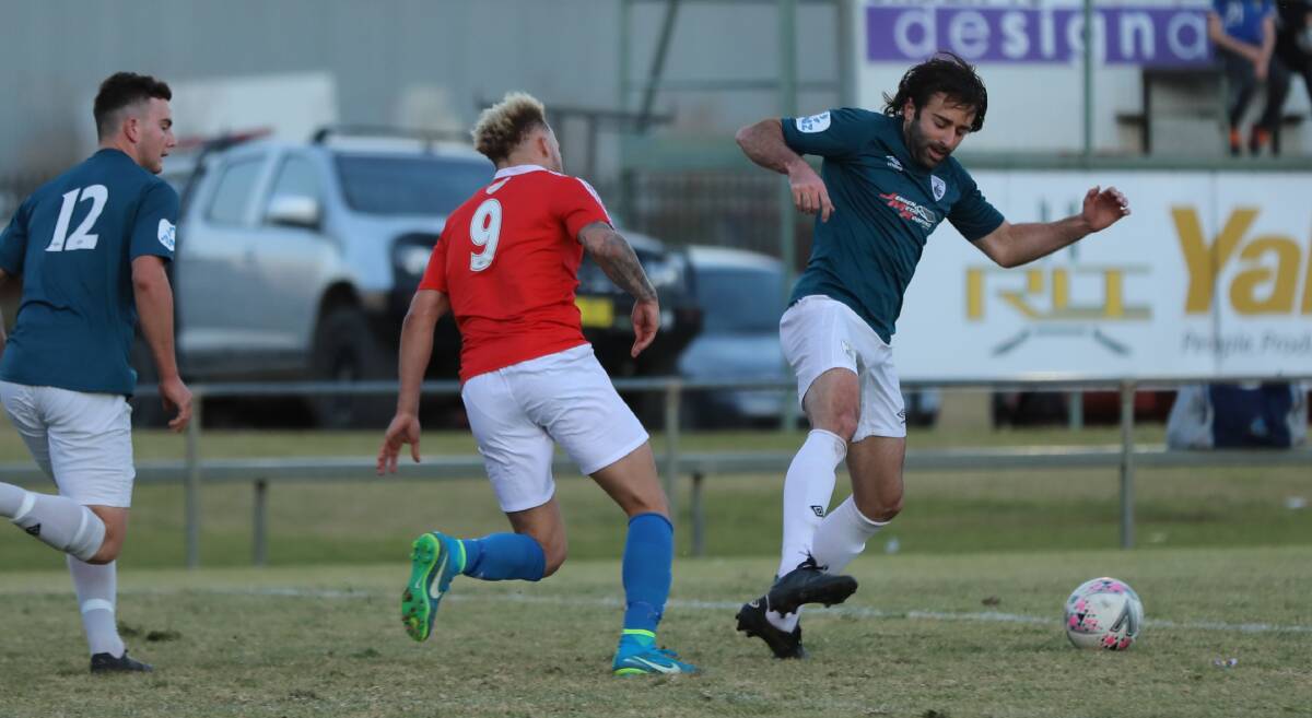 Rhinos' Andrew Vitucci looks to win the ball of his Canberra FC opposition last weekend. PHOTO: Andrew McLean