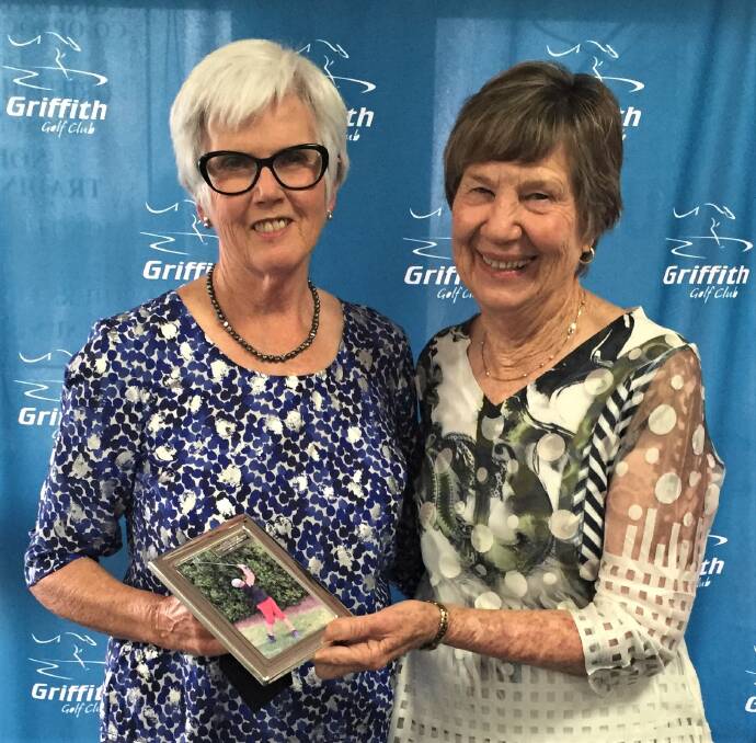 GREAT SERVICE: Retiring women's president Annie Hicks receiving gift from new president Kathy King.