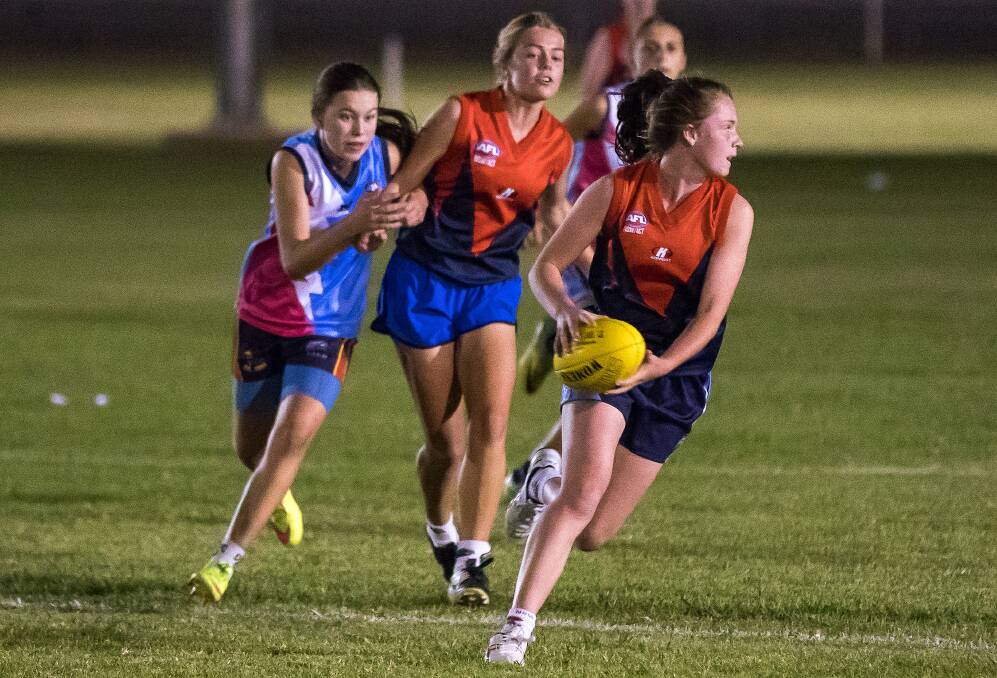 OPTIONS: Paris Crelley looks for open targets while playing in the MIA Youth Girls competition for the Redlegs in their finals loss to Griffith recently. PHOTO: Supplied