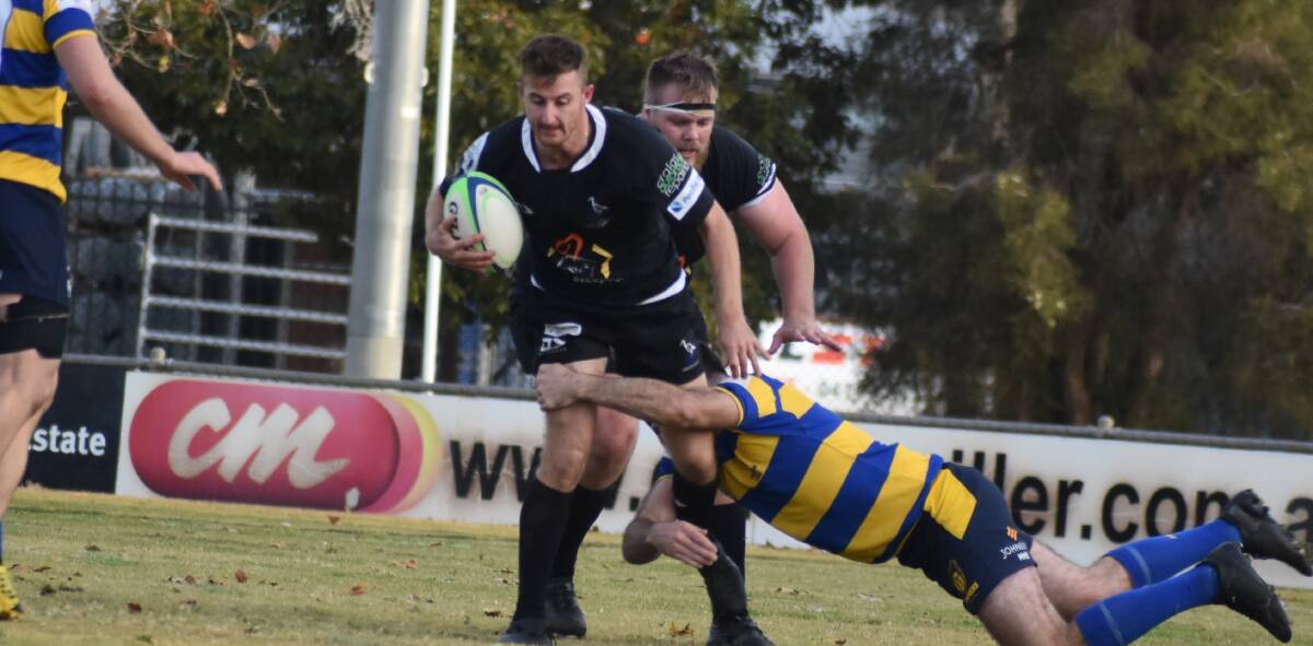 RETURNING: Blacks' Hamish Wrafter looks to break out of an Albury tackle during his sides last match three weeks ago. PHOTO: Liam Warren