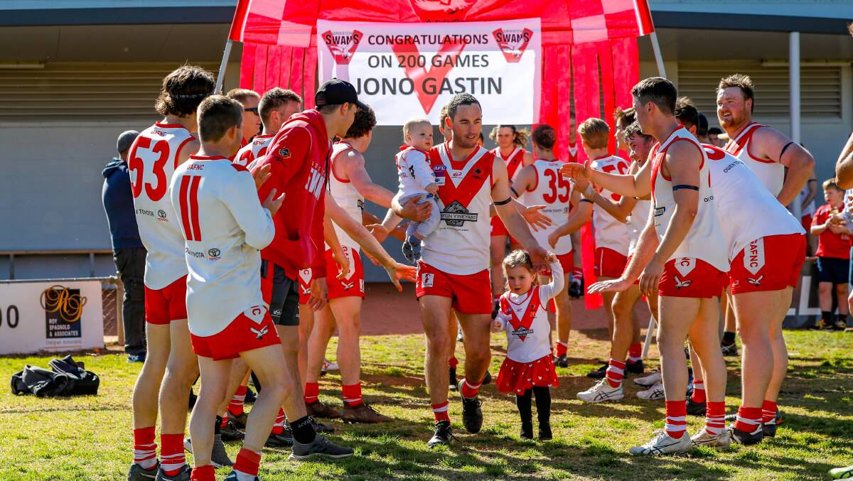 HANGING UP THE BOOTS: Jono Gastin cheered onto the ground during his 200th game in 2019 against Mangoplah. PHOTO: Andrew McLean