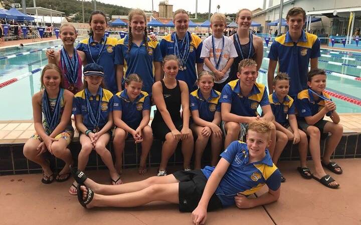 ALL SMILES: It was a strong outing for the Griffith Swim Club with plenty of silverware picked up at the 2019 Country Regionals in Wagga. Picture: Supplied.