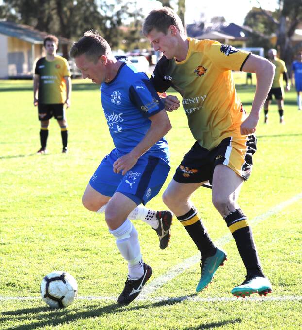 HOLDING OFF: Hanwood's Brad Clark looks to maintain possession while under pressure from the Tumut defence during Hanwood's last match of the regular season. PHOTO: Les Smith