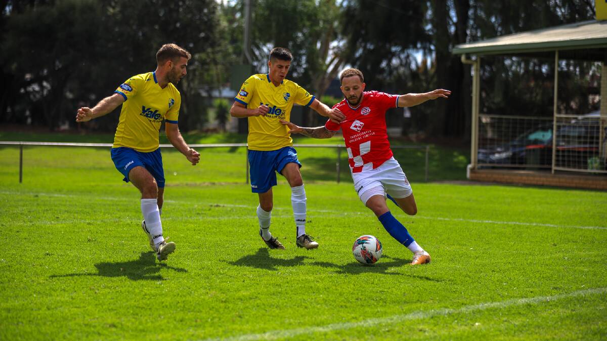 Yoogali SC's Lucas Fabris and Mason Donadel look to close down Canberra Croatia's Thomas James. Picture by Declan Smith