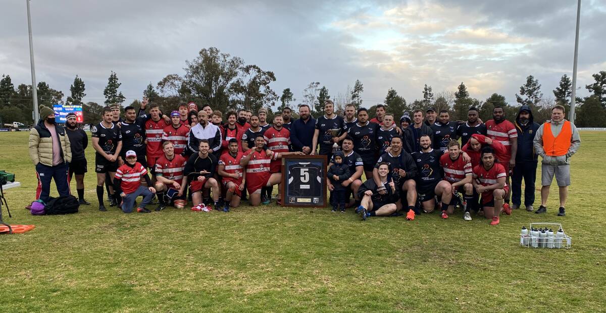 UNITED: Griffith and CSU come together after the Blacks took out the Ben Groat Cup on a wintery Saturday afternoon. PHOTO: Liam Warren