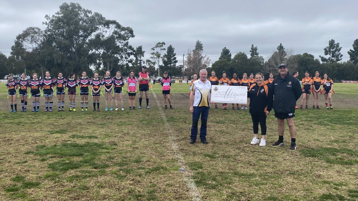 GREAT EFFORT: Waratahs hand over $4000 to Griffith Can Assist after a successful day of fundraising in memory of club stalwart Michelle Donavan. PHOTO: Liam Warren 