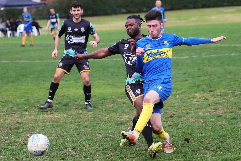 TIGHT BATTLE: Yoogali SC Dom Galluzzo battles for possession during his side's clash with Wagga City Wanderers. PHOTO: Emma Hillier