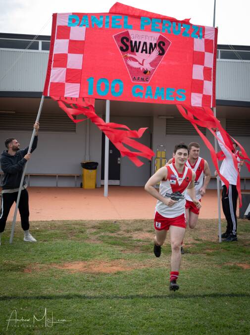 Swans' Daniel Peruzzi runs out for his 100th first grade game. PHOTO: Andrew McLean Photography