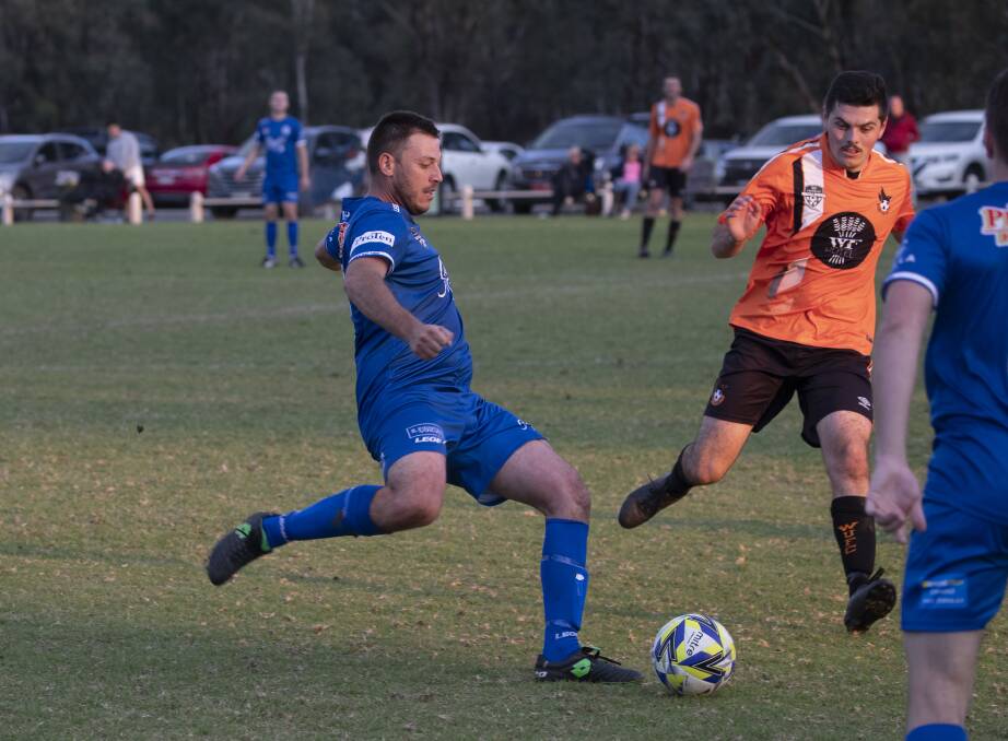 ROLLING ON: Hanwood's Dem Torino looks to get the ball away before being closed down by Wagga United defence last weekend. PHOTO: Madeline Begley