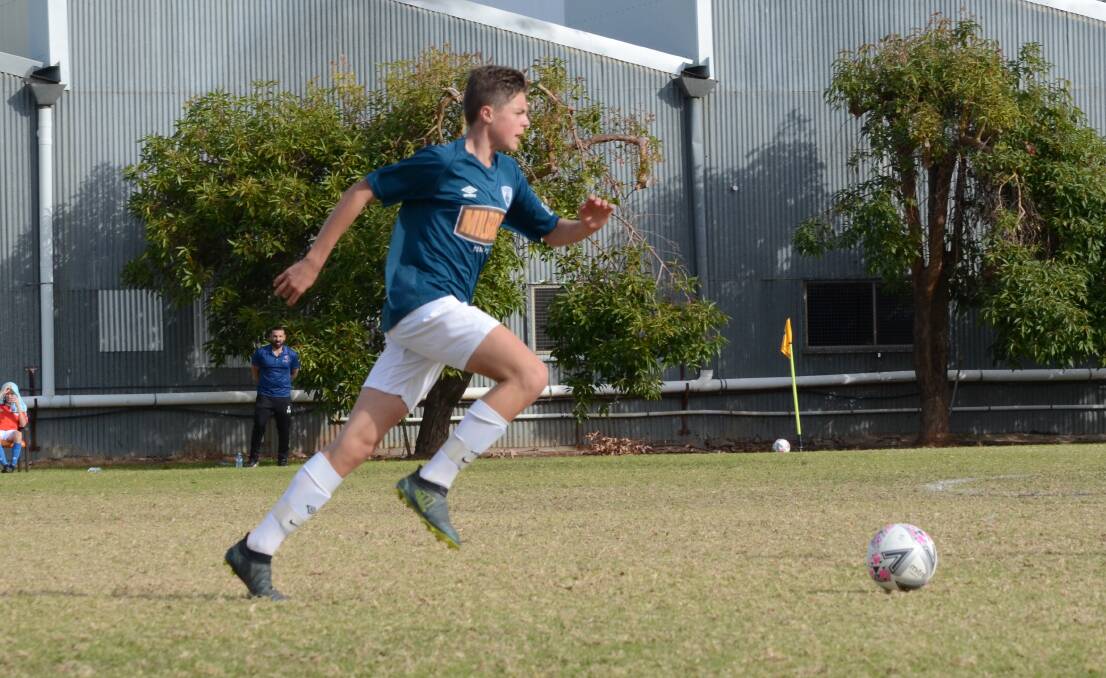 Alex Robinson advances up the field during a clash with Canberra FC in the under 16s competition last season.