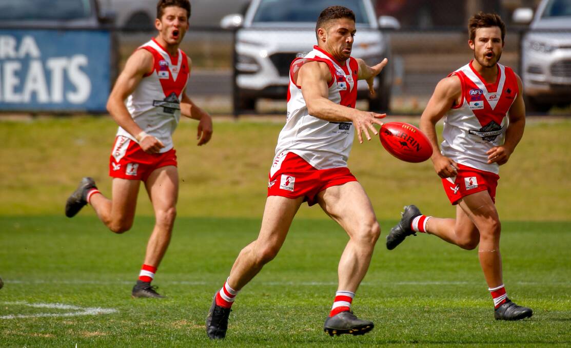 GOING LONG: Rocky Perre sends one long during the Swans major semi final against Collingullie GP. They will take on the Demons again next weekend in the decider. PHOTO: Andrew McLean