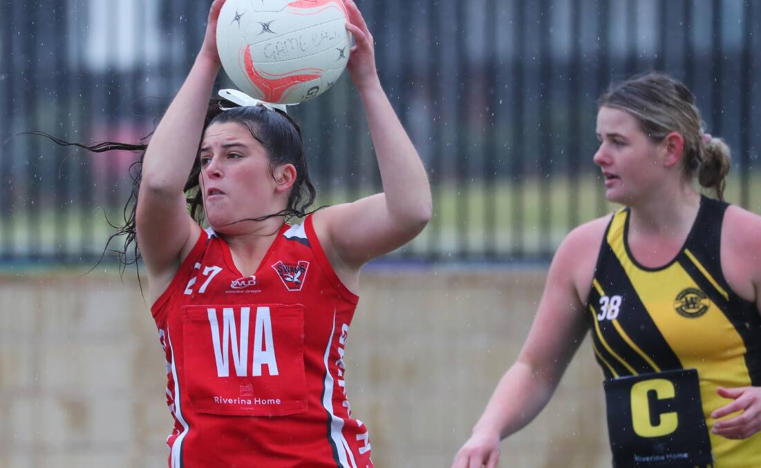 WET WEEKEND: Swans' Milla Parr looks to pull the ball in during their clash with Tigers at Robertson Oval. PHOTO: Emma Hillier