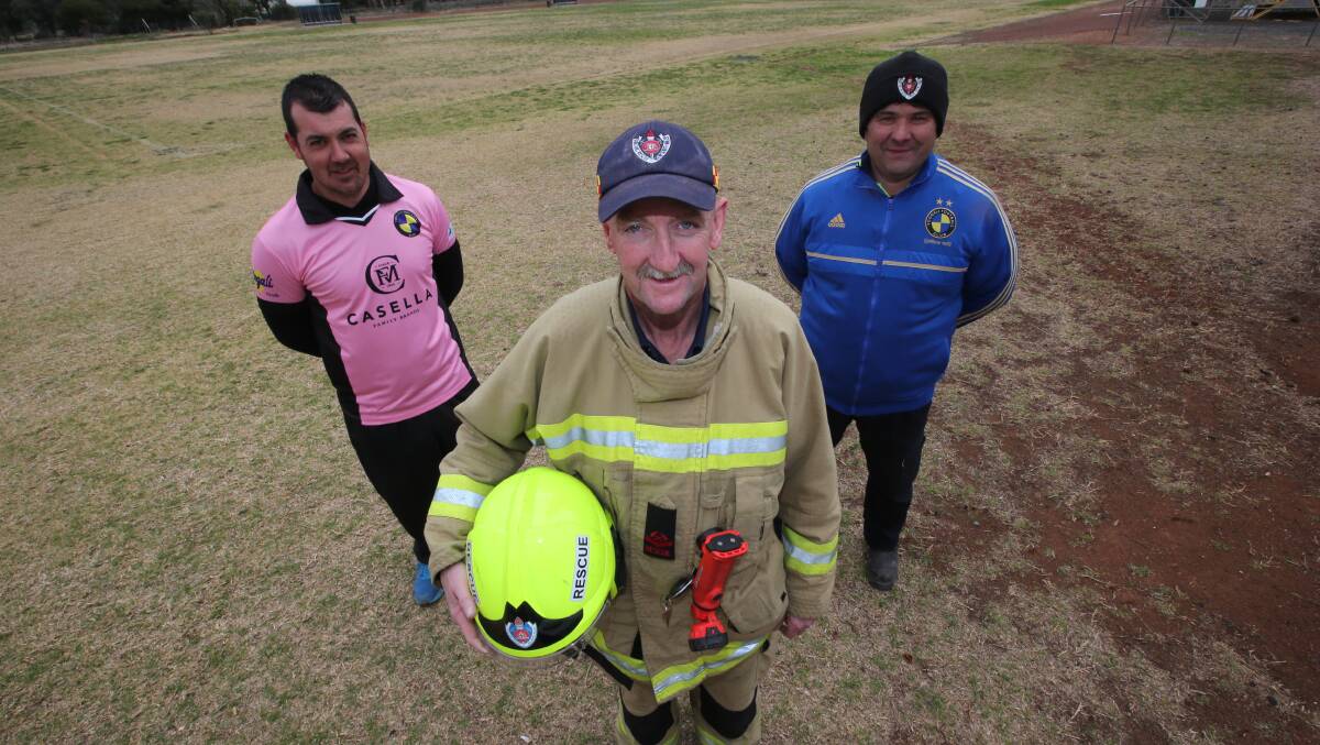GETTING BEHIND CAUSE: Fire and Rescue NSW's Chris Evans with Yoogali FC's Joel Scarfo and Vito Montagner ahead of the fundraising for ‘Firies climb for MND'. PHOTO: Anthony Stipo