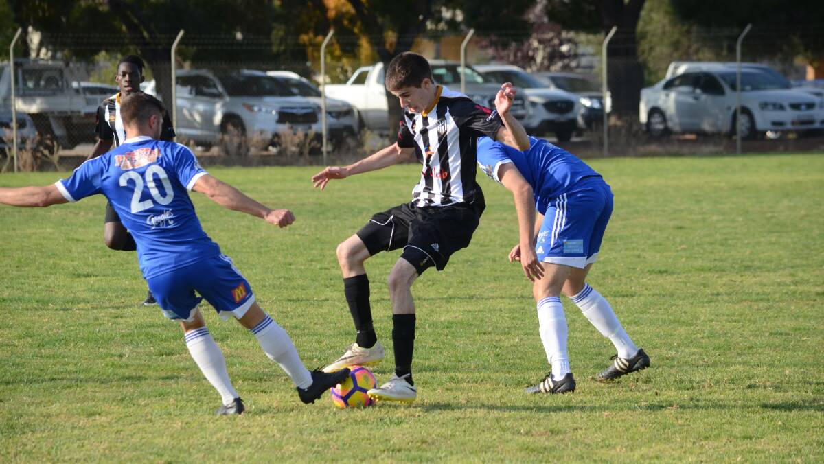 EVADING TACKLES: Wests' Thomas King tries his hardest to spin out of the Hanwood defence in their 5-1 loss. PHOTO: Liam Warren