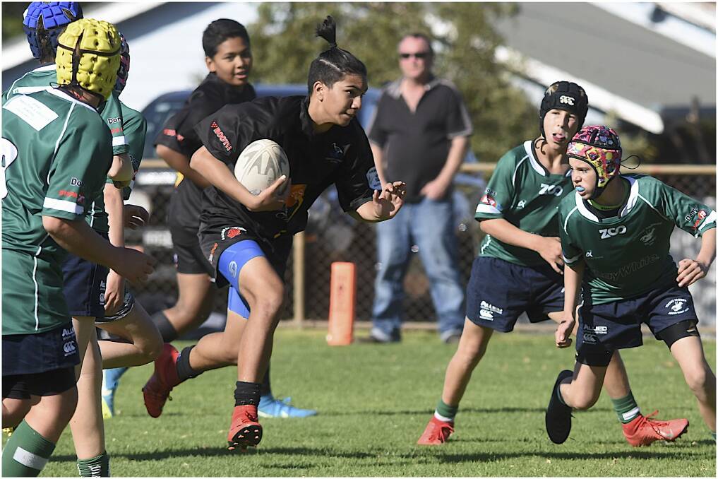 BREAKING THROUGH: Liam Martin looks to make metres for the under 14s Griffith Blacks side last season. The junior season will get under way on July 26. PHOTO: Steven Parisotto