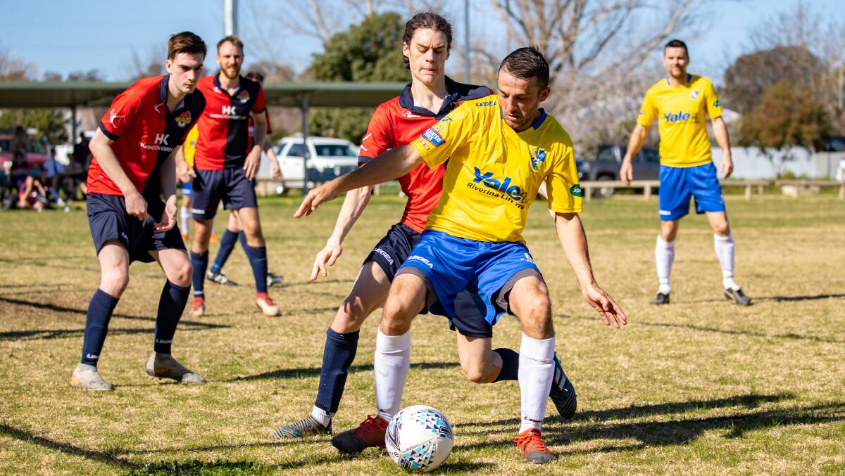 HOLDING OFF: Yoogali SC's Joe Preece looks to shield the ball during their win over Narrabundah last weekend. PHOTO: Andrew McLean
