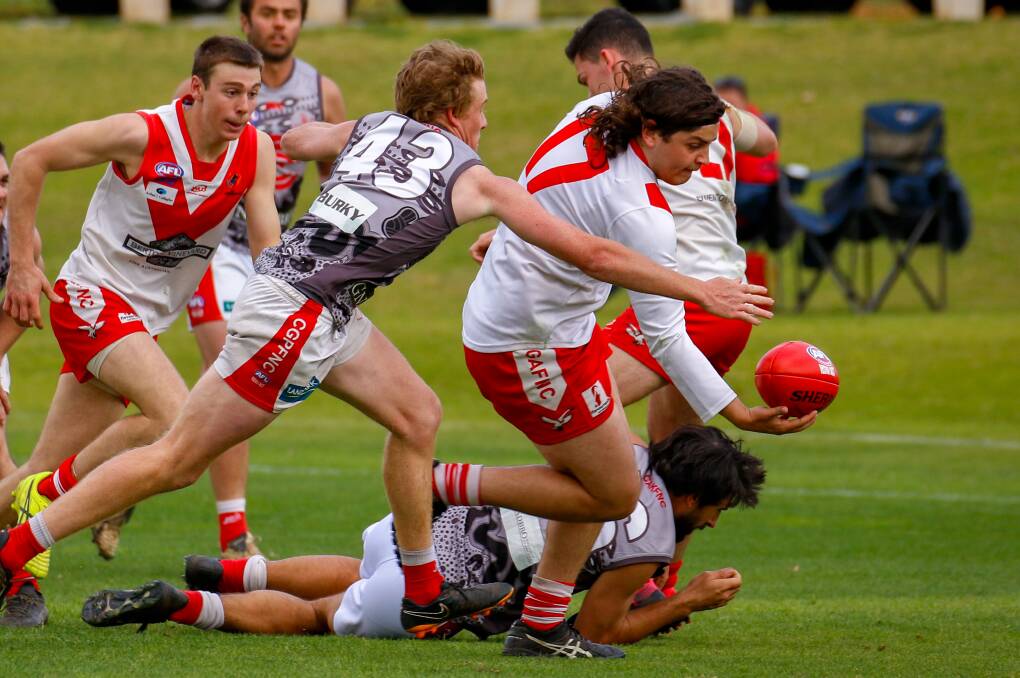 MAN ON: Swans' Sam Foley tries to get the ball away before being tackled during the reserve grade clash with Collingullie GP last weekend. PHOTO: Andrew McLean