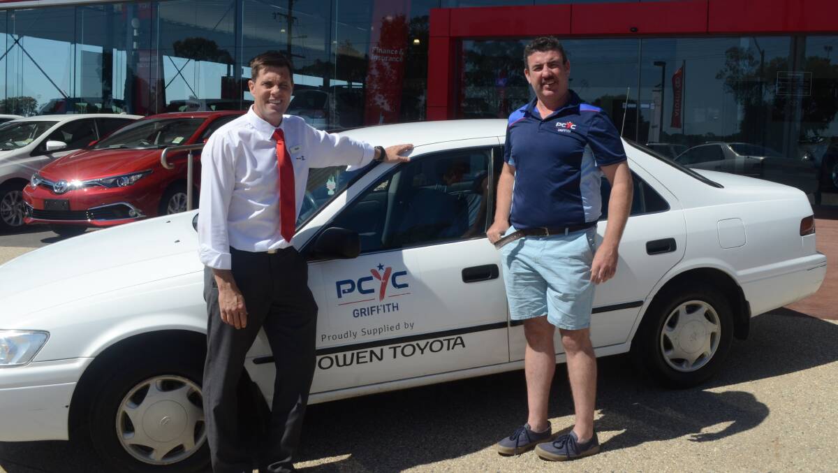 DONATION: Mark Owen from Owen Toyota presents Chris McGregor for Griffith PCYC with the groups new car