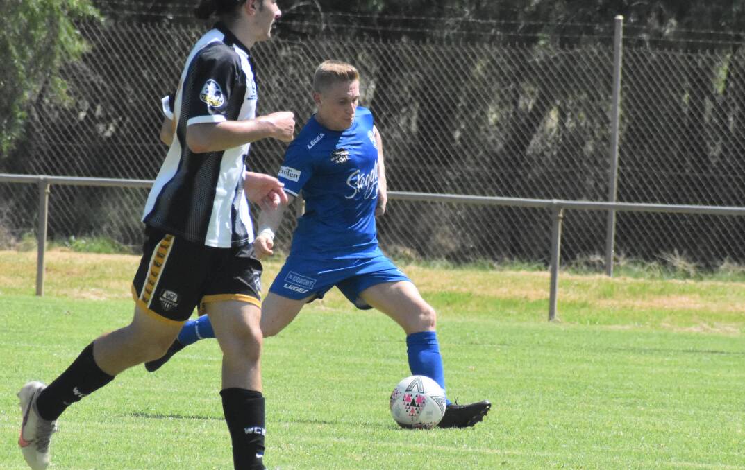 GAME ON: Hanwood's Andy Gamble looks to find the right placement during a preseason game against Wagga City Wanderers. Hanwood will face old foes Yoogali FC this weekend. PHOTO: Liam Warren