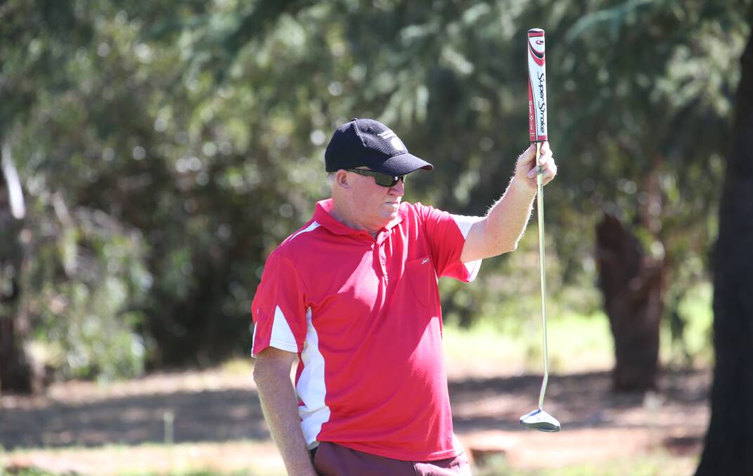 LINE IT UP: Alan Teal measures up his shot at the Griffith Golf Club earlier this month. Picture: Anthony Stipo