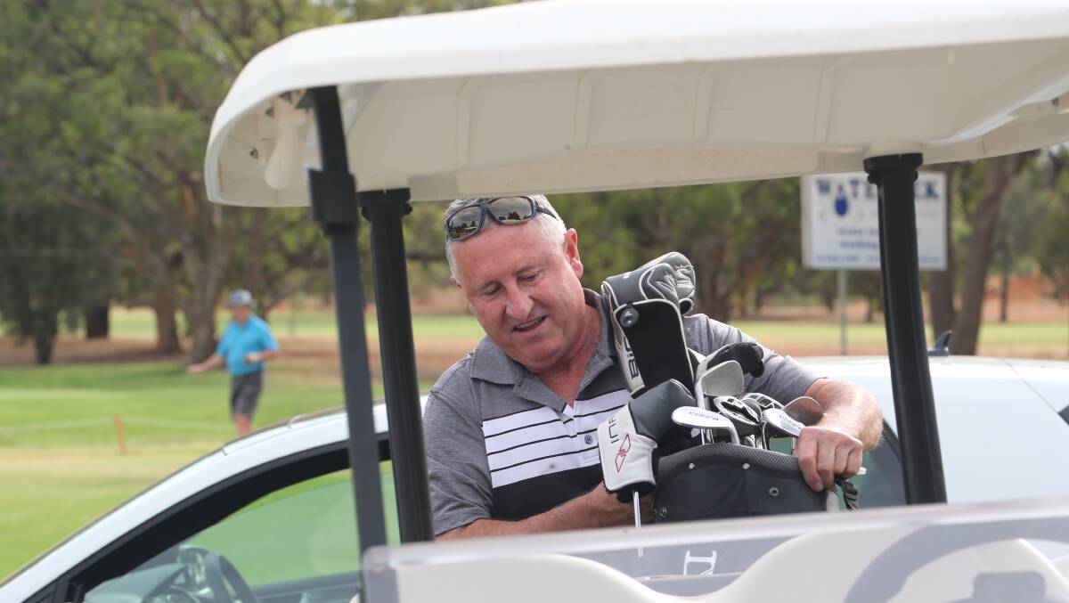 DRIVE AWAY: Peter Gill packs up the cart at the Griffith Golf Club at the weekend. Picture: Anthony Stipo