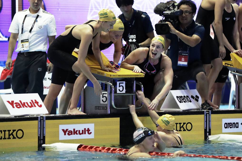 The Australian women's 4x200m freestyle team celebrate victory at the 2018 PanPacs. Picture: Getty Images