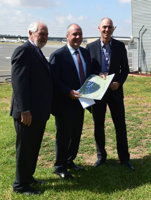 FACELIFT: Mayor Rod Kendall, member for Wagga Daryl Maguire and council's director of economic development Peter Adams examine the runway upgrade.