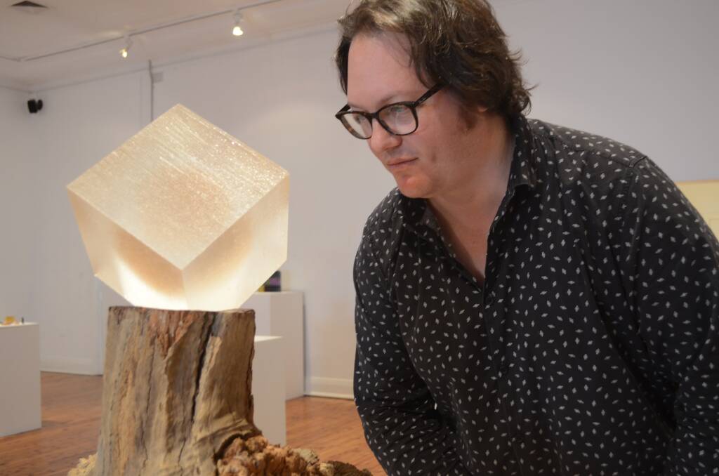 ILLUMINATED: Griffith Regional Art Gallery Coordinator Raymond Wholohan with Highly Commended piece 'Hope Upheld' by Clare Peters. Picture: Sarah Bentvelzen