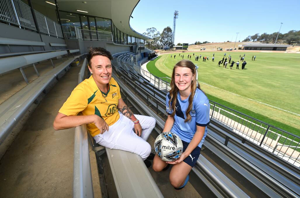 HELPING HAND: Former Matilda, Leeton's Joey Peters, and Albury's Ashleigh Carty, who has aspirations to one day play for Australia, at Lavington Sportsground on Wednesday. Picture: Mark Jesser