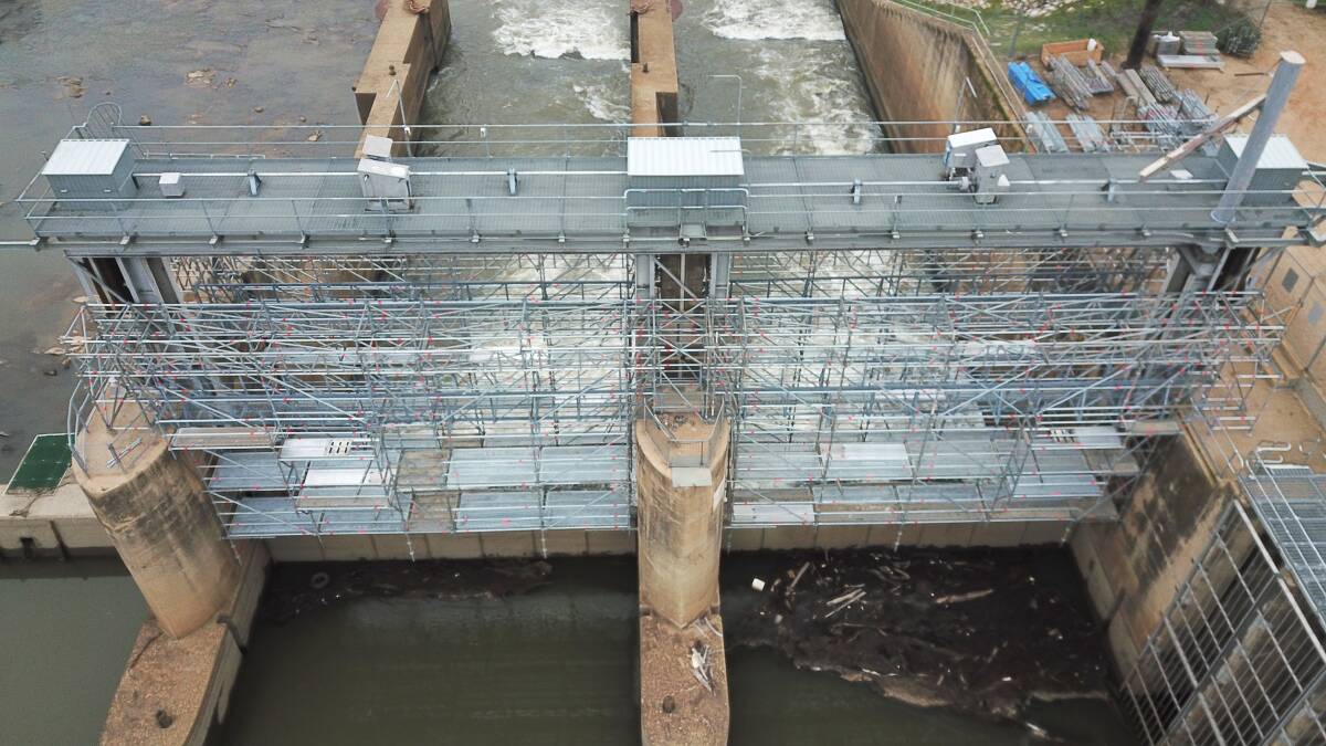 The gates at Berembed Weir being lowered back into the water by WaterNSW after they were recently painted. General security allocations have been increased to three per cent. Photo: Contributed