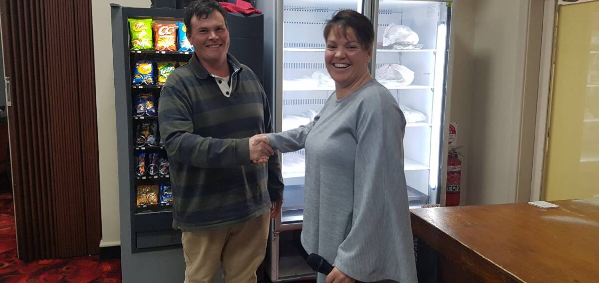 MONEY WELL SPENT: Publicity officer Carl Chirgwin presents Sally Irons from the Barellan Netball Club with the funds. Photo: Contributed