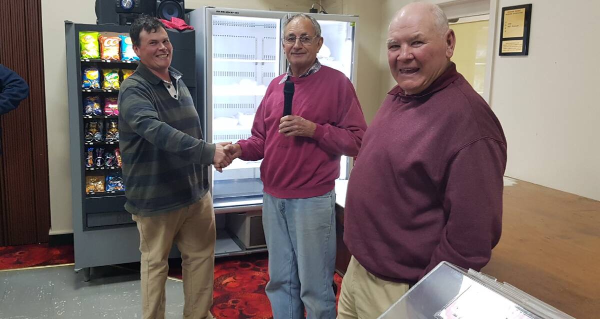 Carl Chirgwin present Jeff Jackson and Aub Norris from the Barellan & District Bowling Club with their funds.