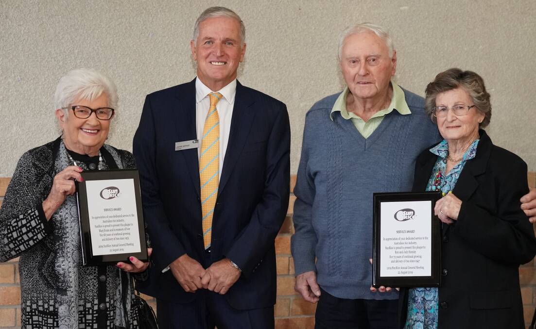 FARM STRONG: SunRice chairman Laurie Arthur awarding Marj Evans, Ron Hemley and Judy Hemley. PHOTO: Supplied