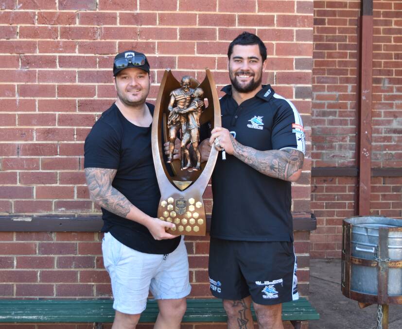 CHAMPION: Tim Rice and Andrew Fifita holding the 2016 NRL premiership trophy at Murrumbidgee Regional High School. PHOTO: Ben Jaffrey