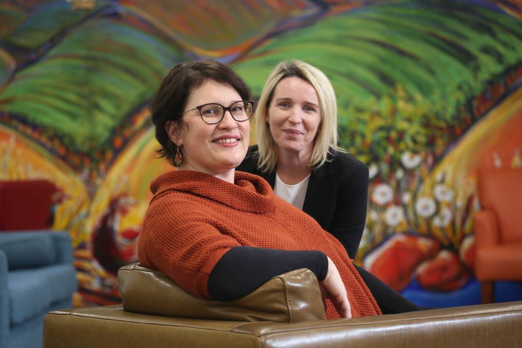 GIFT GIVERS: Janine Cunial and Sharmaine Delgado work at Griffith City Library. PHOTO: Anthony Stipo