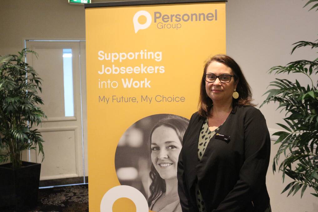 STANDING PROUD: Melanie Norris next to the banner for Personnel Group at the mental health seminar. PHOTO: Shaun Paterson