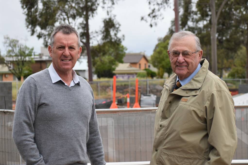 GOING SWIMMINGLY: Max Turner and Mayor John Dal Broi at the construction site of the new outdoor pool. PHOTO: Shaun Paterson