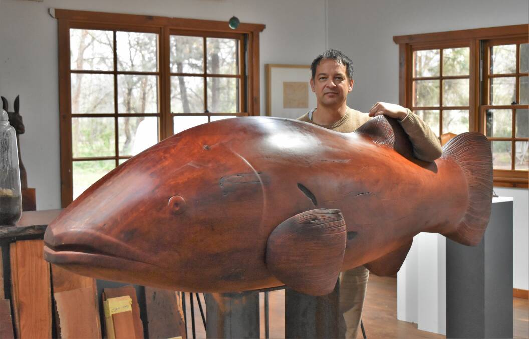 FINISHED: Hape Kiddle with the world's largest Murray Cod statue. PHOTO: Shaun Paterson
