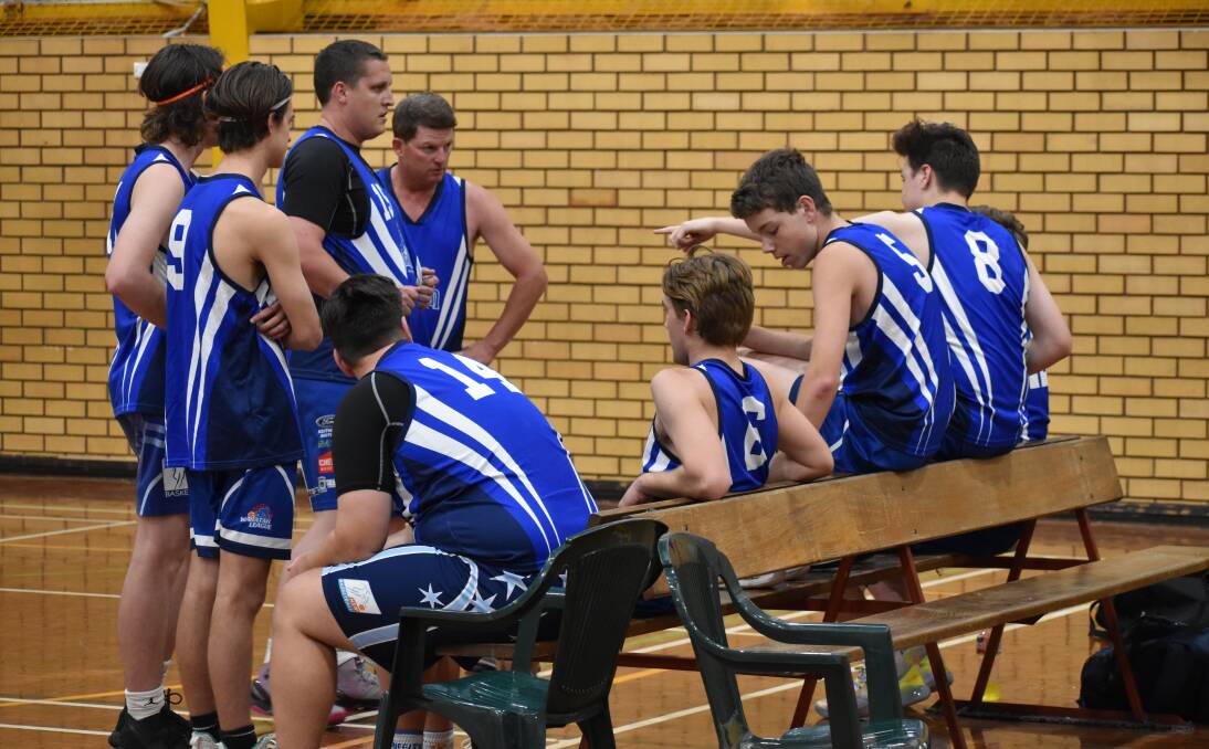 TEAM TALK: Demons chat strategy at half time against Leeton. PHOTO: Shaun Paterson