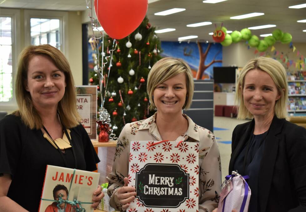 GIFT GIVERS: Shiron Kirkman, Marie Dalo and Sharmaine Delgado from Griffith City Library. PHOTO: Shaun Paterson