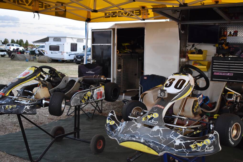 RACING HEARTS: Father and son duo work on their karts next to each other. PHOTO: Shaun Paterson