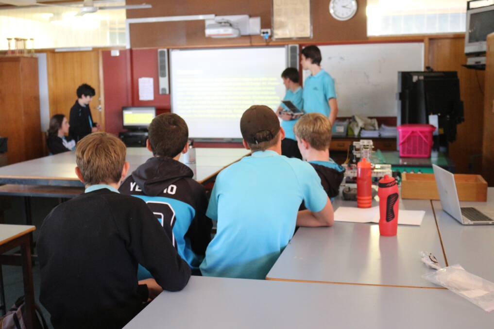 PRACTICAL LEARNING: Vehicle designers present a slideshow on solar energy. PHOTO: Shaun Paterson