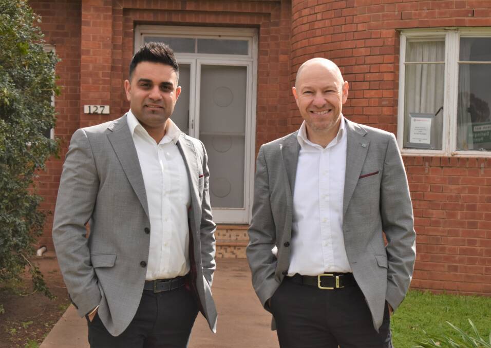 UP FOR AUCTION: Griffith Real Estate's Nick Chauhan and Brian Bertolin at 127 Banna Avenue. PHOTO: Shaun Paterson
