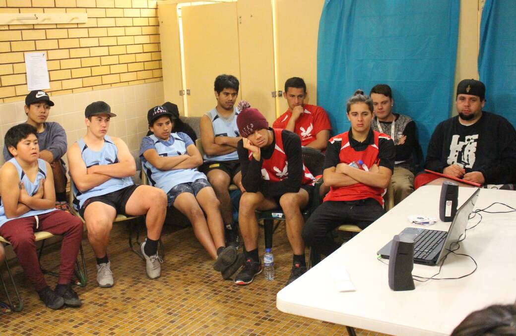 Griffith Midnight Basketball players and coaches watch an educational DVD as part of a workshop. Picture: Andrew Piva 
