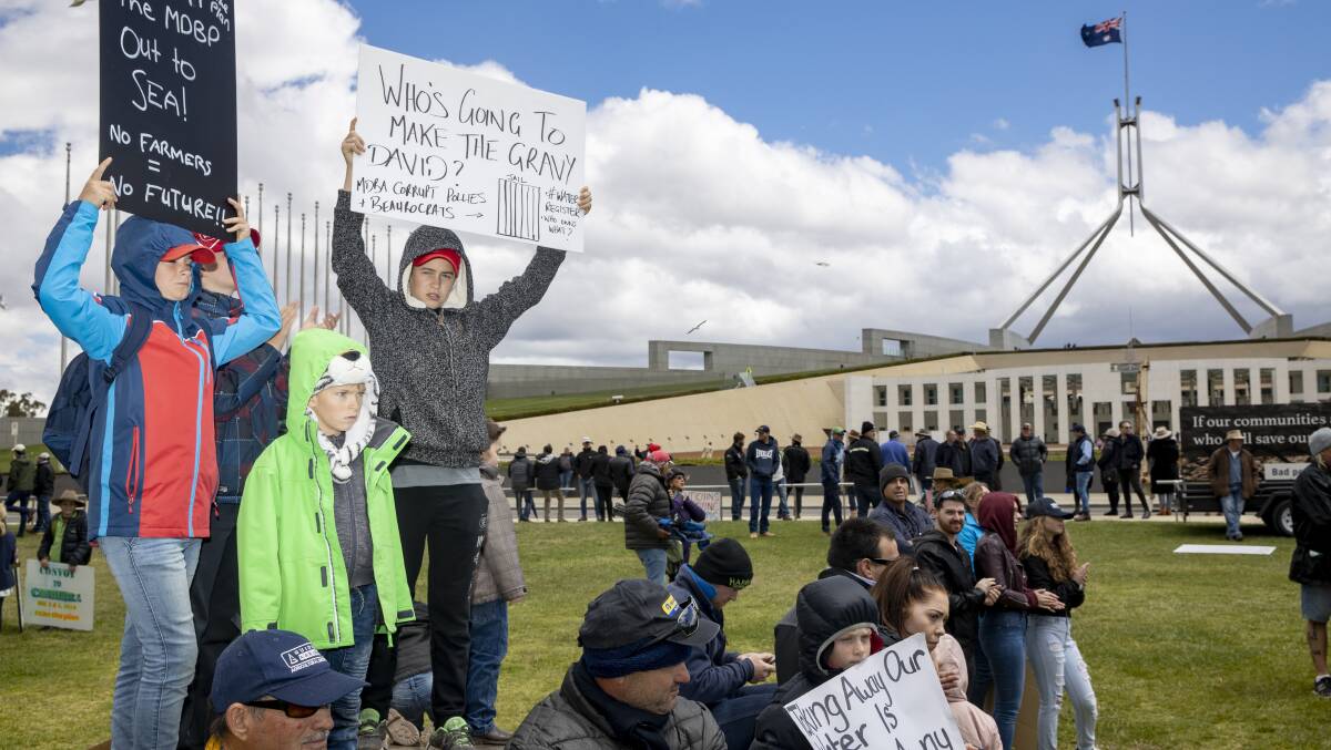 Reuben (11) and Jude (7) Haley, and their cousin Jack Villa (12) from Griffth protest the Murray Darling Basin plan at Parliament House. Picture: Sitthixay Ditthavong