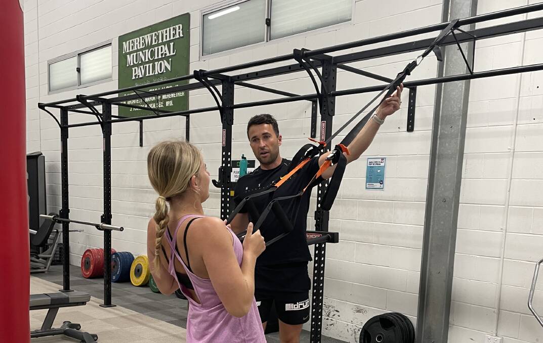 RETURN TO ACTION: Personal trainer Scott Hingston, who operates out of Green Life Gym in Merewether, guides Tiana Sargeant through a banded exercise. Picture: Supplied