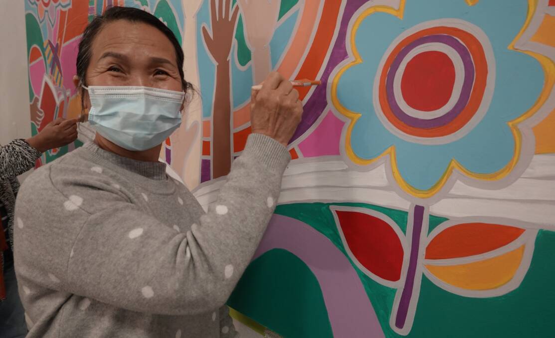 ART: Huong Tran is learning to speak english at TAFE Griffith and was one of the students who helped paint the new mural. PHOTO: Monty Jacka