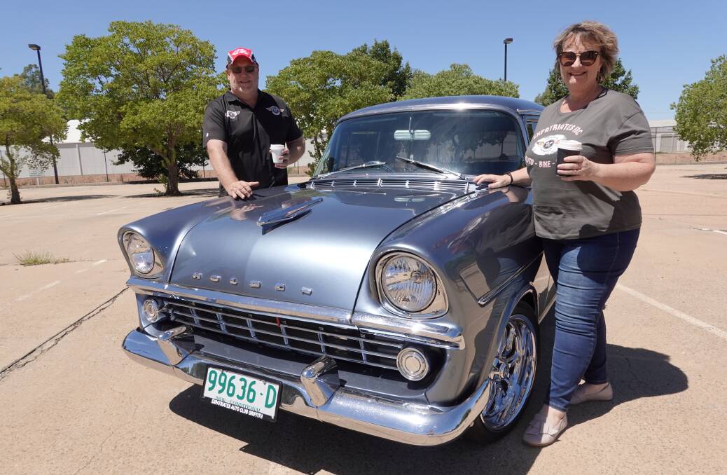 COFFEE AND CHROME: Expatriates Auto Club's Stephen and Sharon Brown share a coffee alongside their beloved 1960 custom Holden FB, fitted with a V8 engine. Photo: Monty Jacka